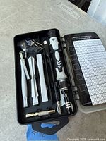 Open case showing driver handle, spudgers, suction cup and accessories