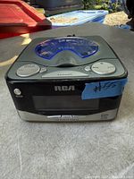 Front and top view of RCA CD clock radio showing controls and display