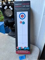 Front of boxed tabletop curling game showing product name and graphics