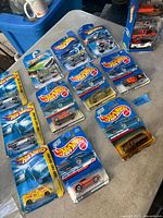 Overhead view of fifteen single Hot Wheels blister packs and one 5-car gift pack