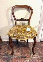 Front view of carved walnut balloon-back dining chair