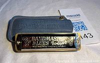 Harmonica front view in case showing branding