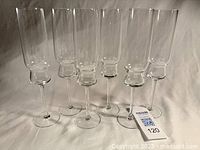 Six clear glass champagne flutes lined up