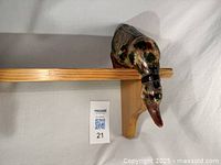 Front view of pine shelf with duck decoy perched