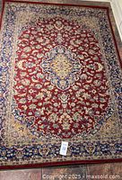 Full view of the rectangular Persian-style rug laid flat on floor