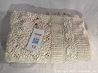 Tablecloth folded showing crochet texture