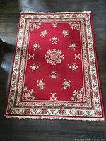 Full view of red oriental rug showing design and overall condition