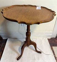 Full view of pedestal table showing tripod base and overall form