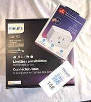 Retail boxes of Philips Hue starter kit and Globe Electric smart plug