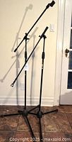 Pair of Quiklok boom mic stands shown fully assembled
