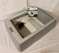 Overall view of PetSafe ScoopFree litter box base showing control panel, rake and quick-start guide
