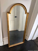 Front view of gold arched mirror