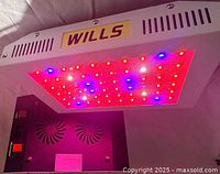 Underside of one WILLS grow light lit, showing LED array and housing