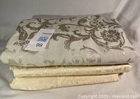 Stack of three folded tablecloths showing colors and patterns