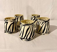 Front view of all five zebra-pattern shades standing upright