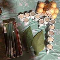 Overall view of candles, holders, leaf candles and box of tapers