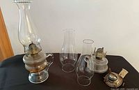 Full lot showing assembled finger lamp, additional chimneys, second base and loose burner