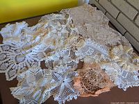 Assorted lace doilies spread on table