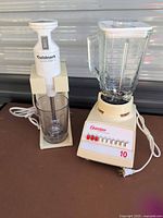 Cuisinart immersion blender on stand beside Osterizer blender base