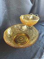 Large and small amber Concord bowls assembled with bracket
