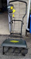 Full view of snow thrower with handle and body