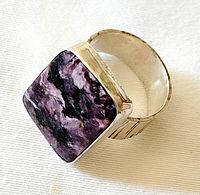 Top view showing purple rectangular stone set in silver bezel