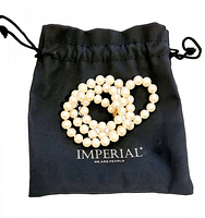 Necklace coiled on black Imperial drawstring pouch