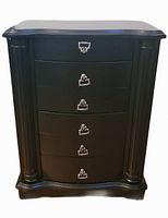 Front view of black jewelry cabinet showing five curved drawers and side columns