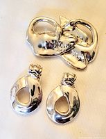 Full view of brooch and earrings showing design and finish