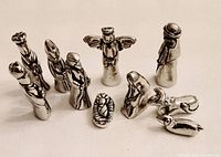Front view of all pewter nativity pieces arranged upright
