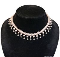 Front view of choker necklace on display bust showing pearl and crystal fringe design