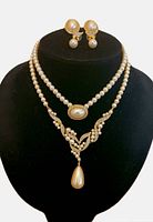 Front view of both layered necklaces and earrings displayed on bust