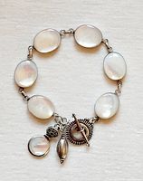 Full view of sterling bracelet with moonstones and charms