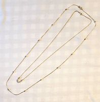 Both sterling silver necklaces laid out fully