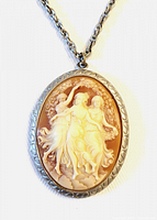 Front view of oval cameo locket showing three-figure carving and bezel detail