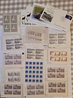 Overview of all stamp blocks and covers spread on table