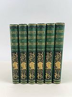 Spine view of all six volumes showing uniform gilt titles and volume numbers