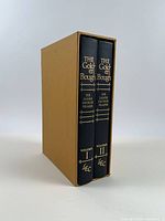 Volumes I and II in tan slipcase, spines visible