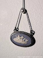 Front view of blue jasperware cameo pendant on chain