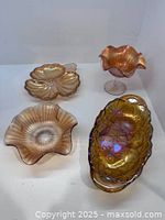Group shot of all four marigold carnival glass pieces