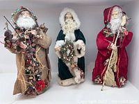 Front view of all three Father Christmas figurines