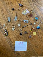 All keychains spread on wood floor with identification card