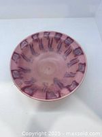 Top view of pink glazed bowl with purple brushwork