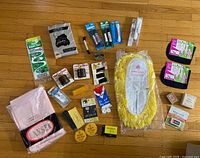 Group shot of all unopened vintage household and personal care items laid out on floor