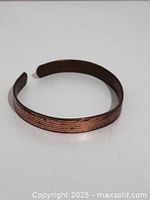 Top view of copper cuff bracelet showing exterior texture