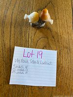 Figurine with reference note showing lot info and dimensions