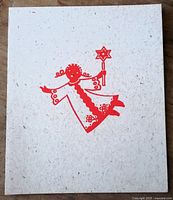 Card with red angel holding wand on speckled cream stock