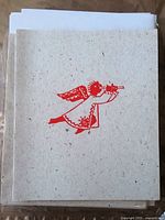 Front view of cards showing red angel graphic