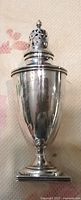 Full view of sterling silver sugar caster with lid in place