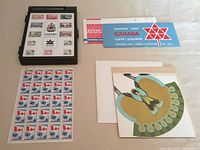 Overall lot showing presentation box, stamp sheet, souvenir card, envelope and paper dolls